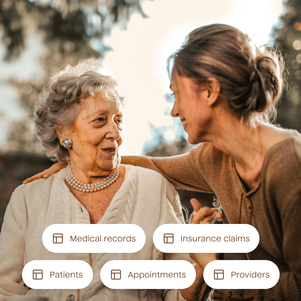 A photograph of two people looking at each other with a list of example data tables overlayed. The data tables included are for Medical Records, Insurance Claims, Patients, Appointments, and Providers.